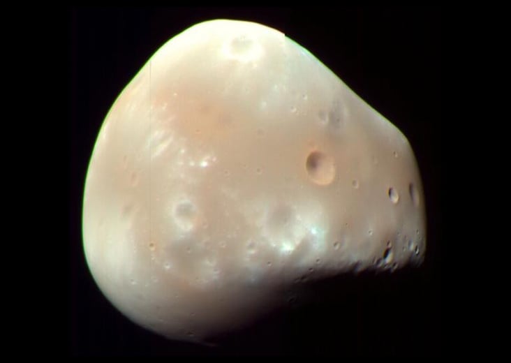 Asteroid Impact Reshaped Deimos, Forming Polar Depression and Smooth Surface